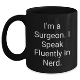 Funny Surgeon Gifts - 'I'm A Surgeon. I Speak Fluently In genius.' Black Coffee Mug for Men or Women, Gifts from Family, Friends, or Coworkers, Father's Day Unique Gifts - Main