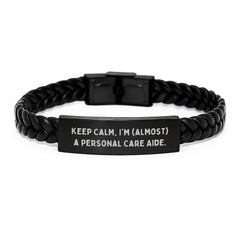 Funny Personal Care Aide Gifts from Friends - 'Keep Calm, I'm (almost) A Personal Care Aide.' Interlaced Leather Bracelet for Birthday - Image 1
