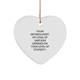 Funny Archeologist Gifts from Friends for Christmas - Heart Ornament with 'I'm An Archeologist. My Level Of Sarcasm Depends On Your Level Of Stupidity.' Quote - Image 1